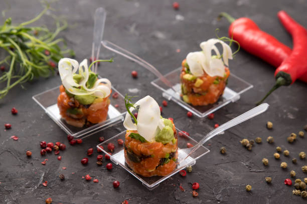 istock Salmon tartar on a dark background with peppers and herbs 1253823521