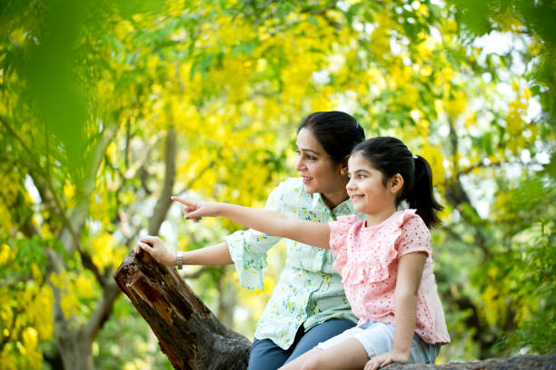 istock Mother and daughter admiring view at park 1253823635