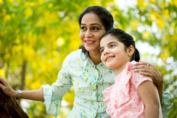 istock Mother and daughter spending leisure time at park 1253823671