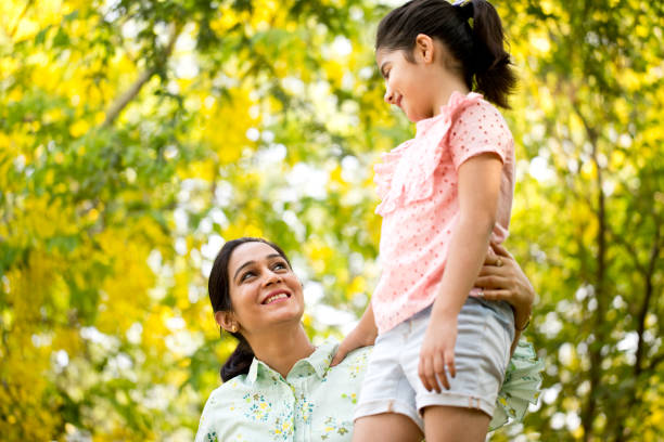 istock Mother and daughter spending leisure time at park 1253823711
