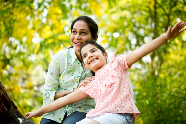 istock Happy mother and daughter at park 1253823732