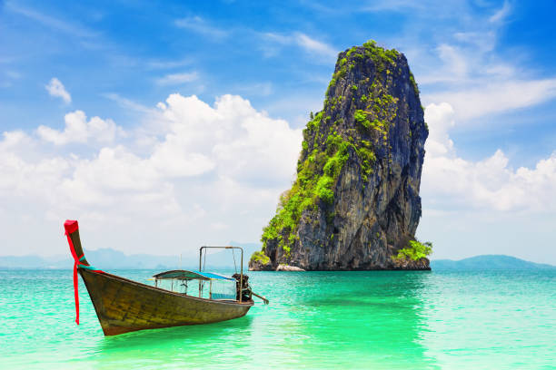 istock Thai traditional longtail boat and beautiful sand beach 1253824498