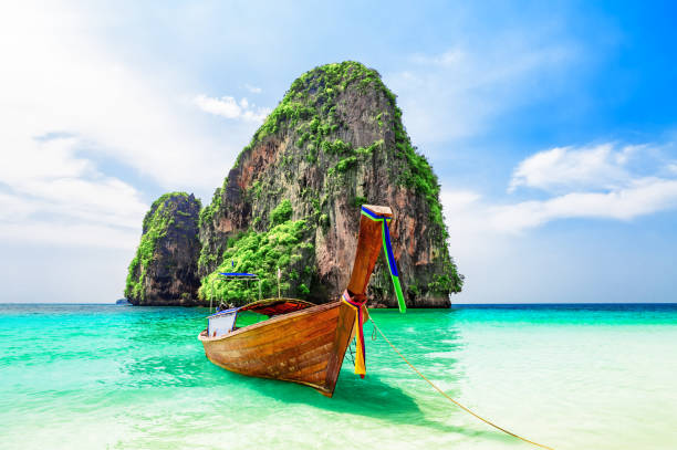 istock Thai traditional wooden longtail boat and beautiful sand beach. 1253824567