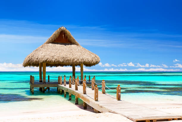 istock Beautiful gazebo on the tropical white sandy beach. 1253824694