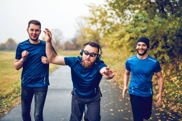 istock Funny Friends Making Jokes While Running In Park 1253828305