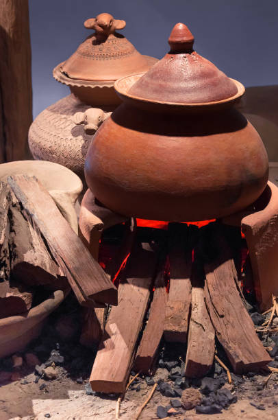 Traditional pottery clay pot on brick campfire with fire