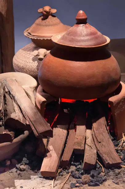 Photo of Traditional pottery clay pot on brick campfire with fire