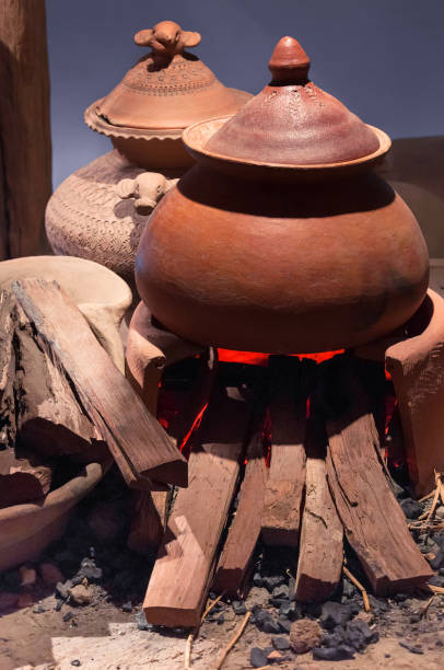 traditional pottery clay pot on brick campfire with fire - earthenware imagens e fotografias de stock