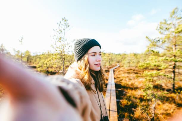 istock Young woman taking a selfie in nature 1253829005