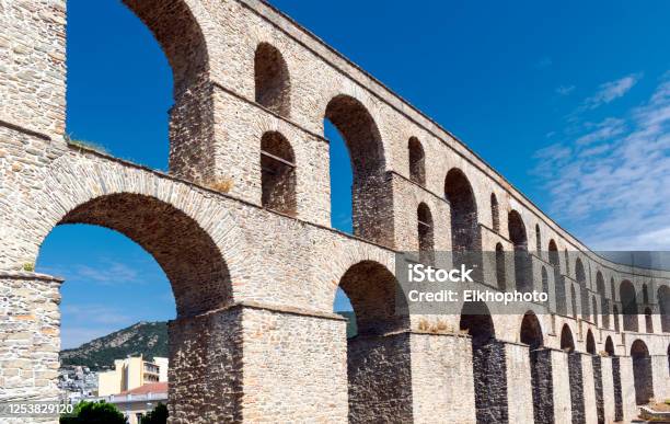 Ancient Aqueduct Kamares Historical Heritage And Architectural Landmark In Greek City Kavala Eastern Macedonia Greece Medieval Aqueduct Blue Sky In Background Copy Space Stock Photo - Download Image Now