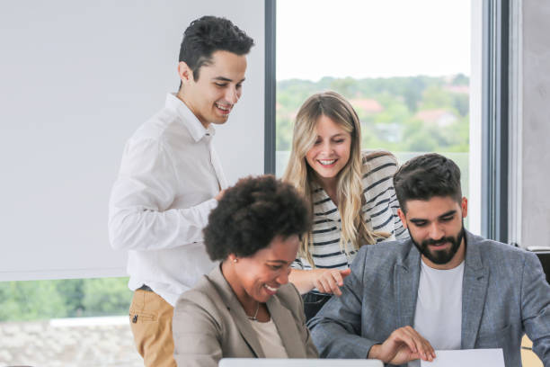 istock Colleagues sitting in a small group discussing something while working at an office 1253831710