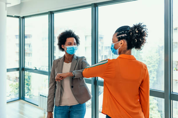 istock Colleagues in the office practising alternative greeting for safety and protection during COVID-19 1253832235