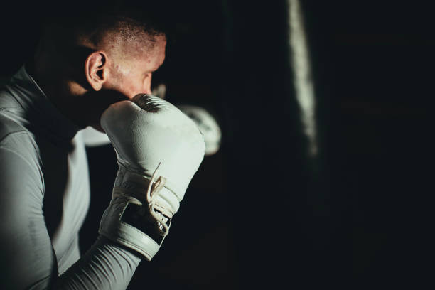 istock Man kick boxer training in the gym 1253832352