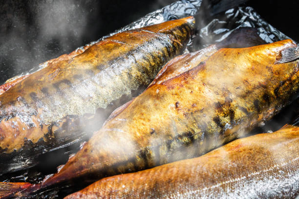mackerel fish is smoked until Golden brown mackerel fish is smoked until Golden brown in the smokehouse kipper stock pictures, royalty-free photos & images