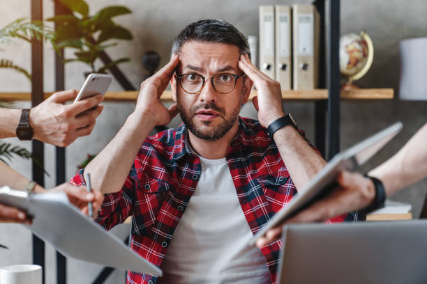 istock Overworked businessman sitting at laptop overloaded with work multiple tasks in modern office 1253833443