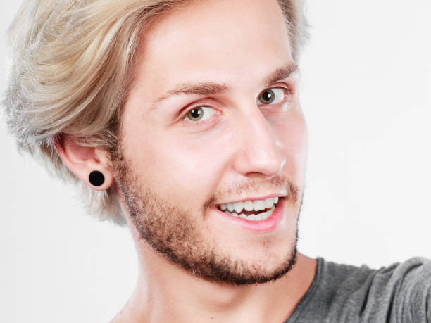 istock Happy smiling blonde man close up 1253833782