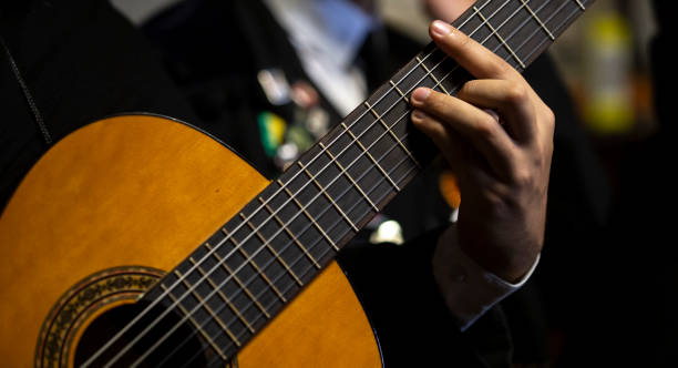 Details from a Portuguese guitar musician of an Academic Tuna, Braga, Minho, Portugal. Details from a Portuguese guitar musician of an Academic Tuna, Braga, Minho, Portugal. coimbra city stock pictures, royalty-free photos & images