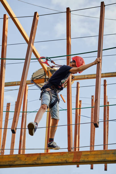 istock Boy walking on the ropes in a rope park 1253834928