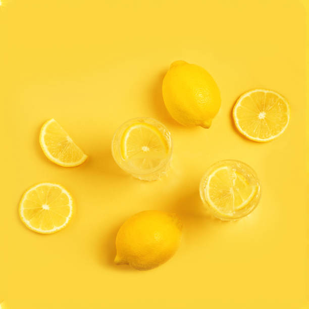 istock Citrus lemonade. Detox with lemon on a yellow background. 1253841013