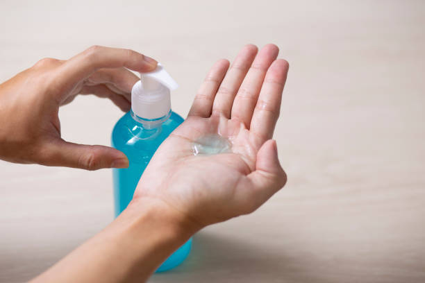 istock using hand sanitizer gel cleaning hands at home 1253841662
