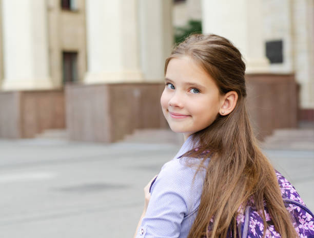 Back to school. Education concept. Cute smiling schoolgirl on the way to the schoo Back to school. Education concept. Cute smiling schoolgirl on the way to the school. Happy little girl child with backpack back to schoo stock pictures, royalty-free photos & images