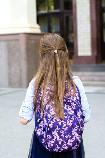 Back to school. Education concept. Cute smiling schoolgirl on the way to the schoo Back to school. Education concept. Cute smiling schoolgirl on the way to the school back view. Happy little girl child with backpack back to schoo stock pictures, royalty-free photos & images