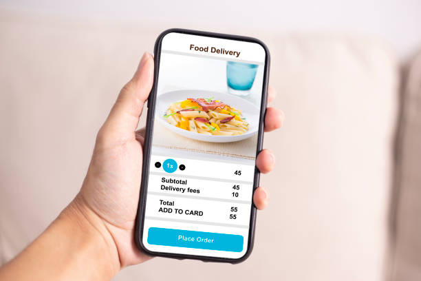 istock holding phone with application delivery food online 1253843470