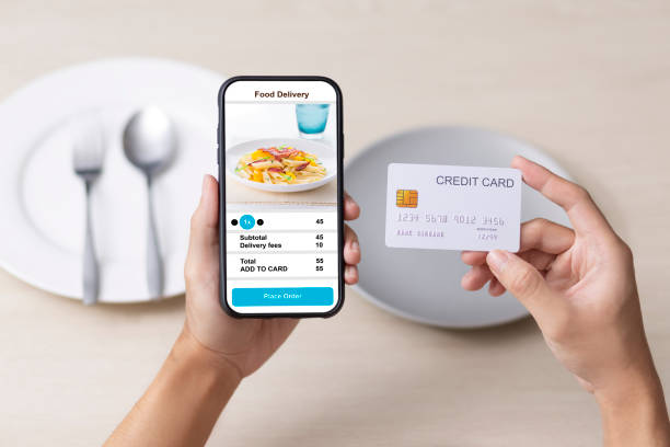 istock holding phone with application delivery food online 1253843481