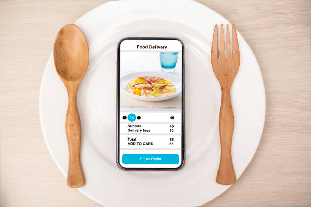 istock holding phone with application delivery food online 1253843587