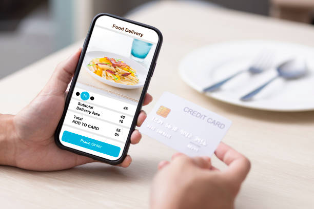 istock holding phone with application delivery food online 1253843630