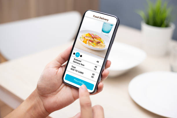 istock holding phone with application delivery food online 1253843671