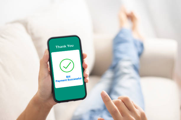 istock using smartphone banking online bill payment at home 1253843733
