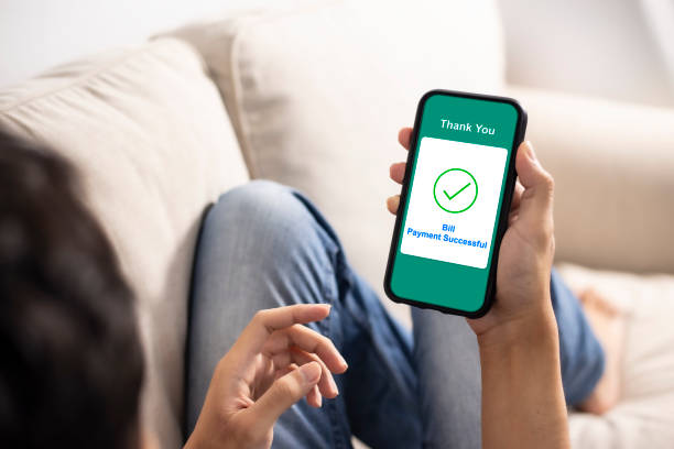 istock using smartphone banking online bill payment at home 1253843744