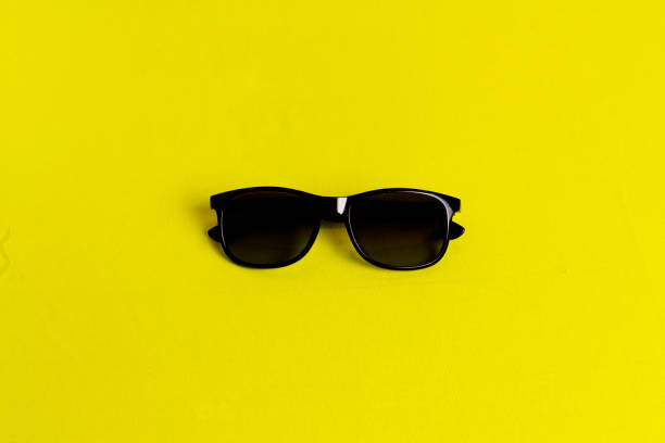 istock sunglasses isolated in a yellow background 1253844087