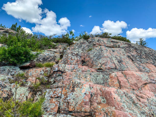 istock Looking up the steep granite rock walk at blue sky 1253844996