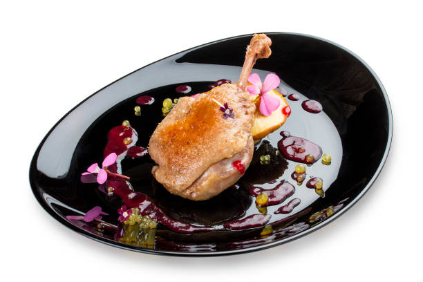 istock Duck leg with caramelized apple on black glossy plate 1253845295