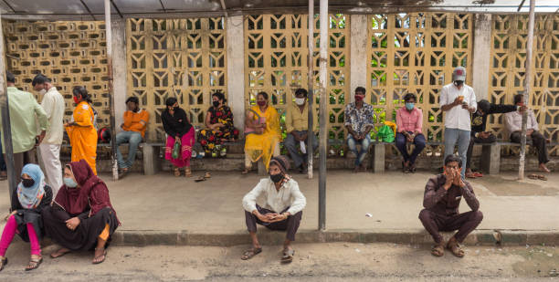 Waiting patients at Covid hospital in Mysore/Karnataka. Patients seen sitting on concrete benches and waiting for their turns for the Covid19 Corona virus testing at the Krishnaraja Wodeyar Hospital in Mysore city of Karnataka state in India. india hospital stock pictures, royalty-free photos & images