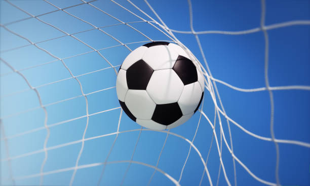 istock Classic soccer ball in goal net 1253847241