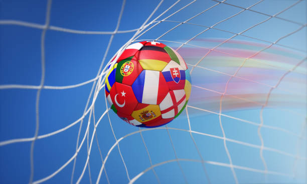 istock Colored soccer ball with flags in goal net 1253847307