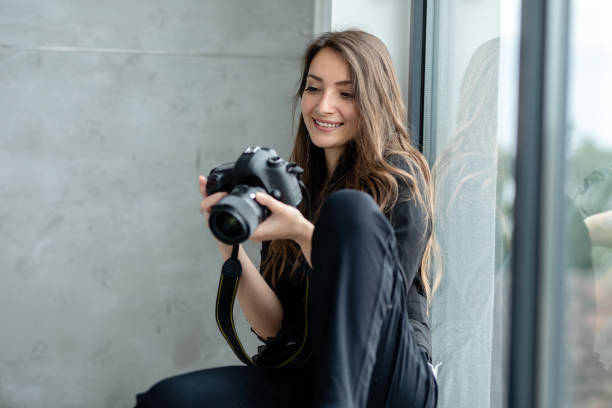 istock Female Photographer working in a studio 1253847386