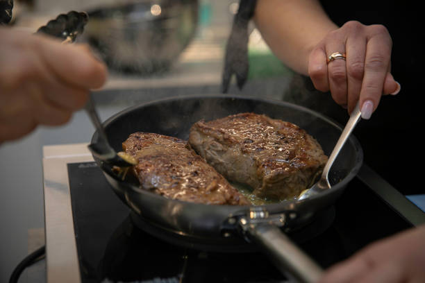 istock Frying meat on frying pans 1253848465