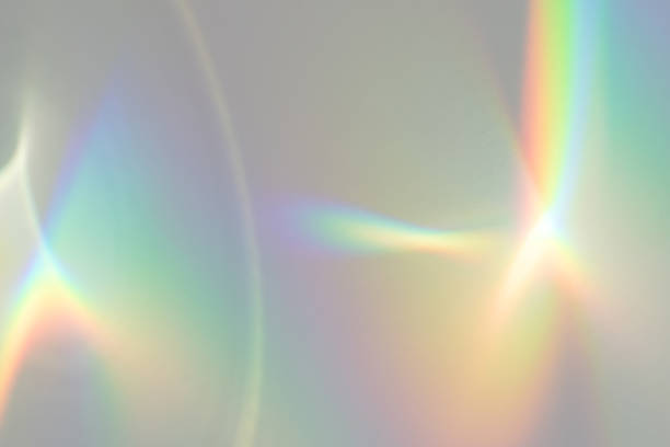 Blurred rainbow light refraction texture on white wall Blurred rainbow light refraction texture overlay effect for photo and mockups. Organic drop diagonal holographic flare on a white wall. Shadows for natural light effects spectrum photos stock pictures, royalty-free photos & images