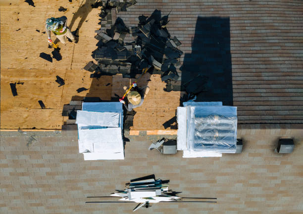 istock Construction worker on a replacement shingles roof the house installed new shingles 1253850098