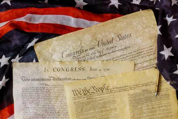 istock Aged historical documents Washington DC on American Declaration of independence 4th july 1776 on USA flag 1253850107