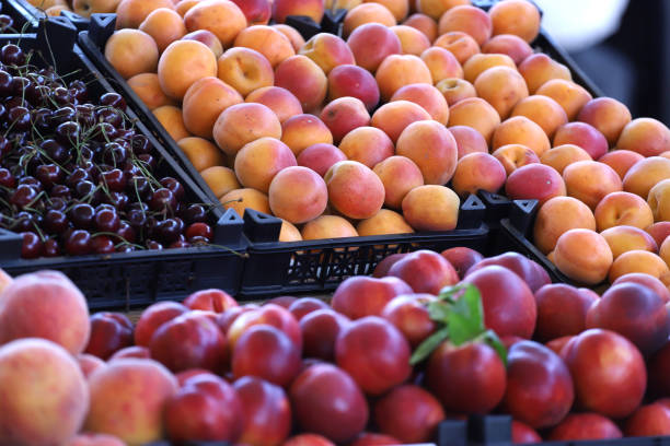 Clorful photo of cherries, peaches, nectarines and apricots on a market. Fruits pattern