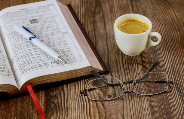 istock Personal Holy Bible study with a cup of coffee on a table top with eyeglasses 1253851273