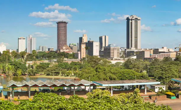 Skyline of Nairobi, Kenya with Uhuru Park in the foreground and a helicopter on top of the KICC.