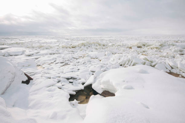 istock Snow covered rocky sea shores 1253851380