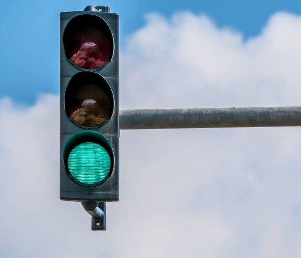 istock Traffic light against blue sky showing the color green 1253851598
