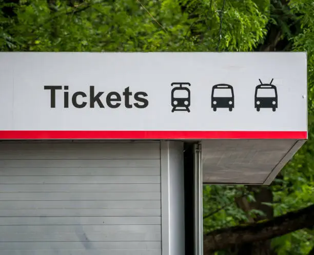 Close up with a public transport tickets booth. Bus, tram and trolleybus symbols on a service booth.